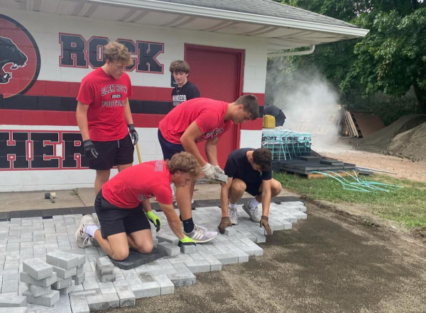 Glen Rock Varsity Football Players helping put in the new stones. 
Photo: Glen Rock Football Instagram